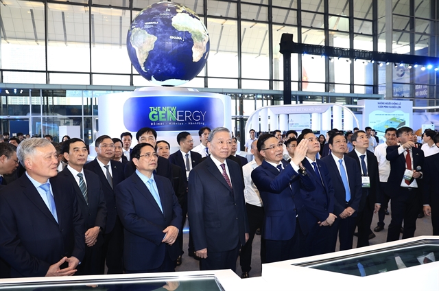 Party General Secretary Tô Lâm, Prime Minister Phạm Minh Chính and high-level officials view the exhibition showcasing Petrovietnam's achievements. — VNA/VNS Photos Quốc Khánh
